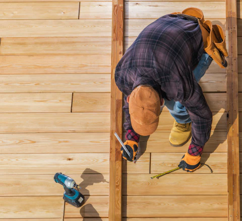 worker building wooden deck
